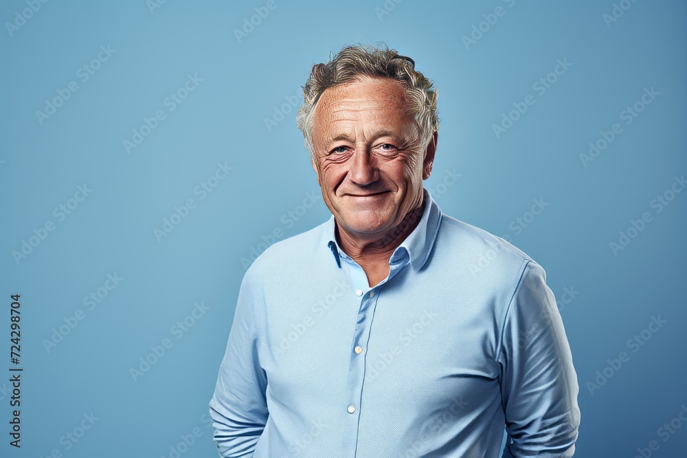 Portrait of a senior man in a blue shirt on a blue background Portrait of a senior man in a blue shirt on a blue background