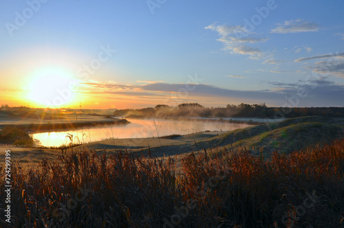Sunrise in the golf course with mist and birds