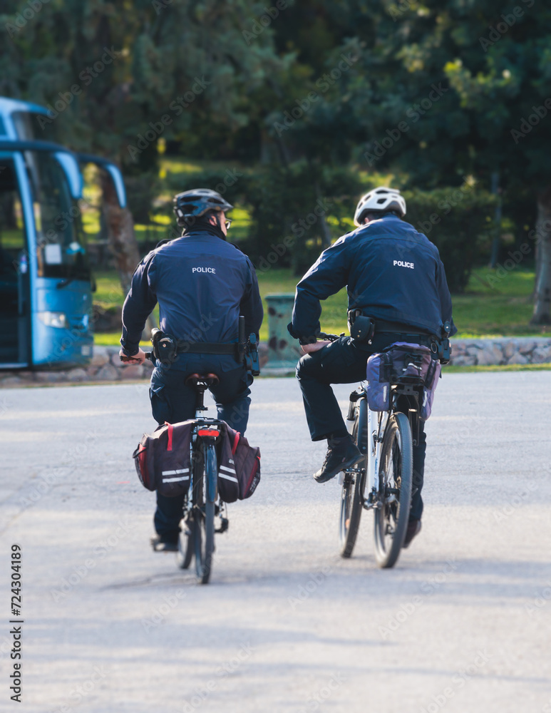 Police squad formation on duty riding bike and bicycle, maintain public order in the european city streets, group of policemen patrol on bycicles with Police squad formation on duty riding bike and bicycle, maintain public order in the european city streets, group of policemen patrol on bycicles with
