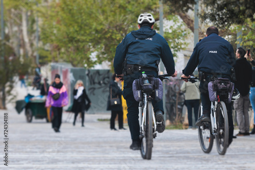 Police squad formation on duty riding bike and bicycle, maintain public order in the european city streets, group of policemen patrol on bycicles with 