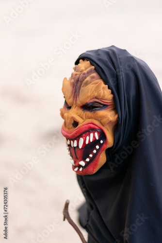 An unidentified person is wearing a horror costume and mask in the Acupe district in the city of Santo Amaro, Bahia. photo