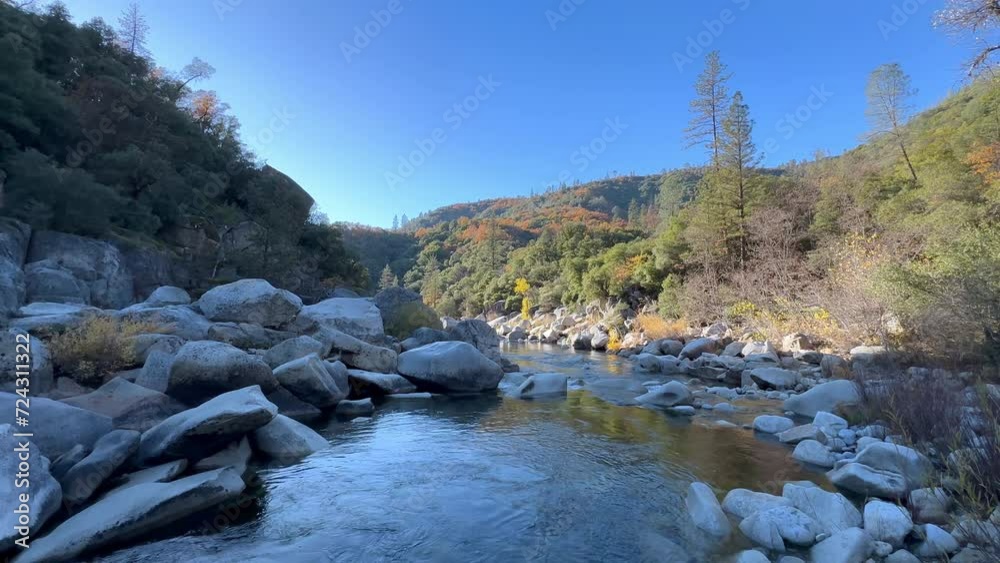 Soothing View of South Yuba River During Autumn. Nevada City, California, USA. 4k. Slow Water Flow with Sun Behind the Mountains Partially Illuminating the Landscape. Soothing View of South Yuba River During Autumn. Nevada City, California, USA. 4k. Slow Water Flow with Sun Behind the Mountains Partially Illuminating the Landscape.
