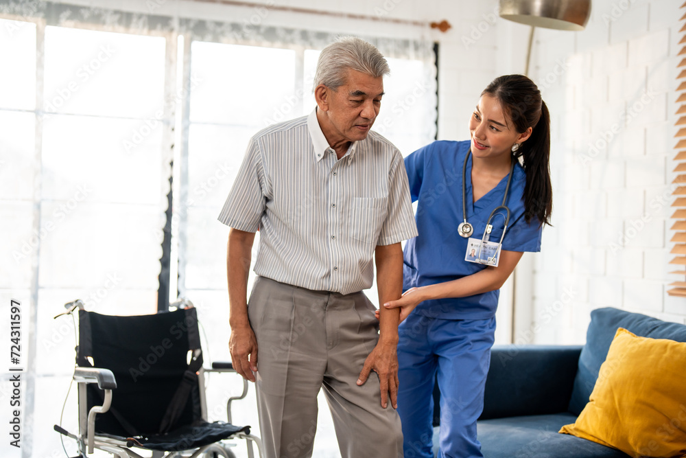 Asian young caregiver take care senior man on wheelchair in house. Asian young caregiver take care senior man on wheelchair in house.