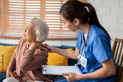 Asian caregiver nurse examine senior female patient with backache. 