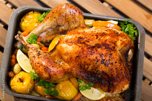 Garnished turkey. Rub turkey with salt, pepper, provencal herbs, honey and balsamic. Covered with foil turkey cook in oven 2 hours at 180 g. Pull off foil, put apples, vegetables and cook 40 minutes.