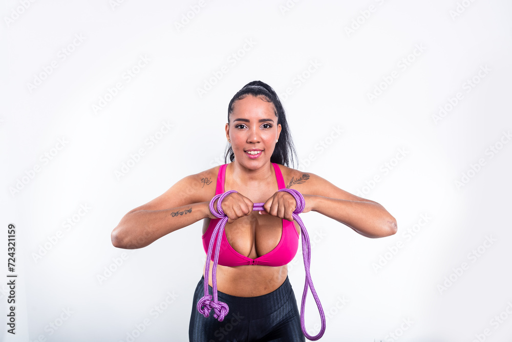 Young gymnast woman, holding lilac rope at torso level. Against white background.