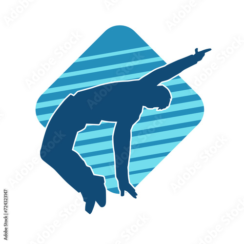 Silhouette of a slim male in dance pose. Silhouette of a man dancing. photo