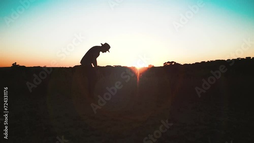 silhouette man at sunset fields