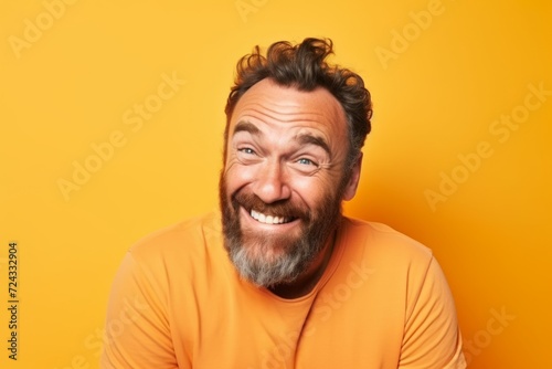 Portrait of a funny man with a beard on a yellow background