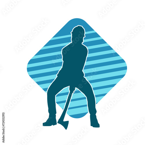 Silhouette of a worker in action pose using his axe tool.