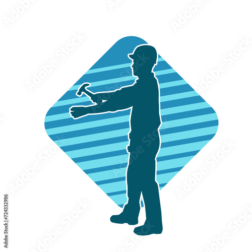 Silhouette of a worker carrying hammer tool. Silhouette of a worker in action pose using hammer tool.
