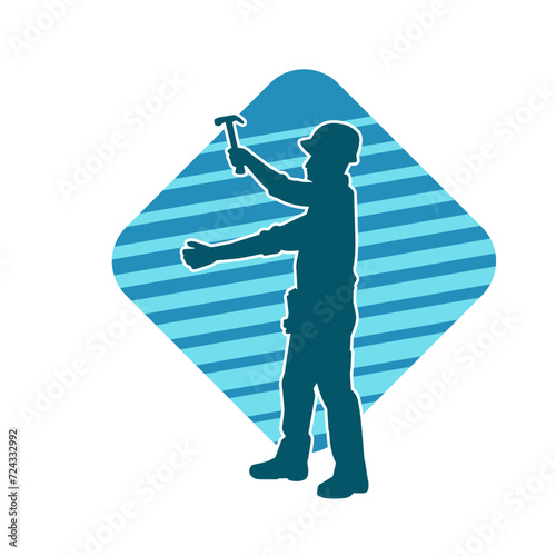 Silhouette of a worker carrying hammer tool. Silhouette of a worker in action pose using hammer tool.