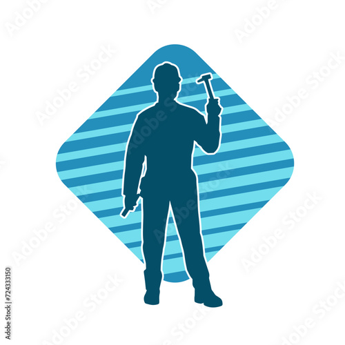 Silhouette of a worker carrying hammer tool. Silhouette of a worker in action pose using hammer tool.