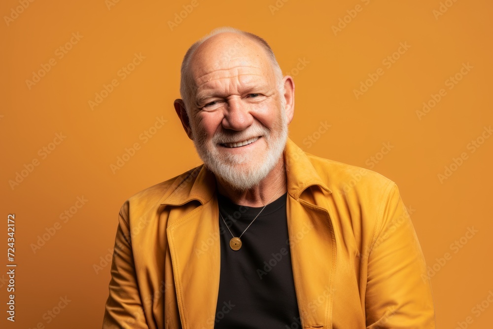 Portrait of a senior man in a yellow jacket on a yellow background Portrait of a senior man in a yellow jacket on a yellow background
