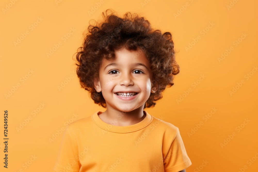 Cheerful african american little boy with curly hair on yellow background Cheerful african american little boy with curly hair on yellow background