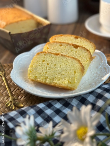 Slices of butter cakes with small white tea set. 