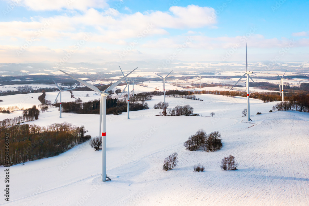 Panoramic view of a wind turbine park in the winter field as a hub of renewable energy production