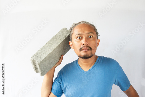 curly asian men phose with light brick.  photo