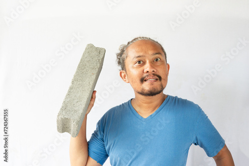 curly asian men phose with light brick.  photo