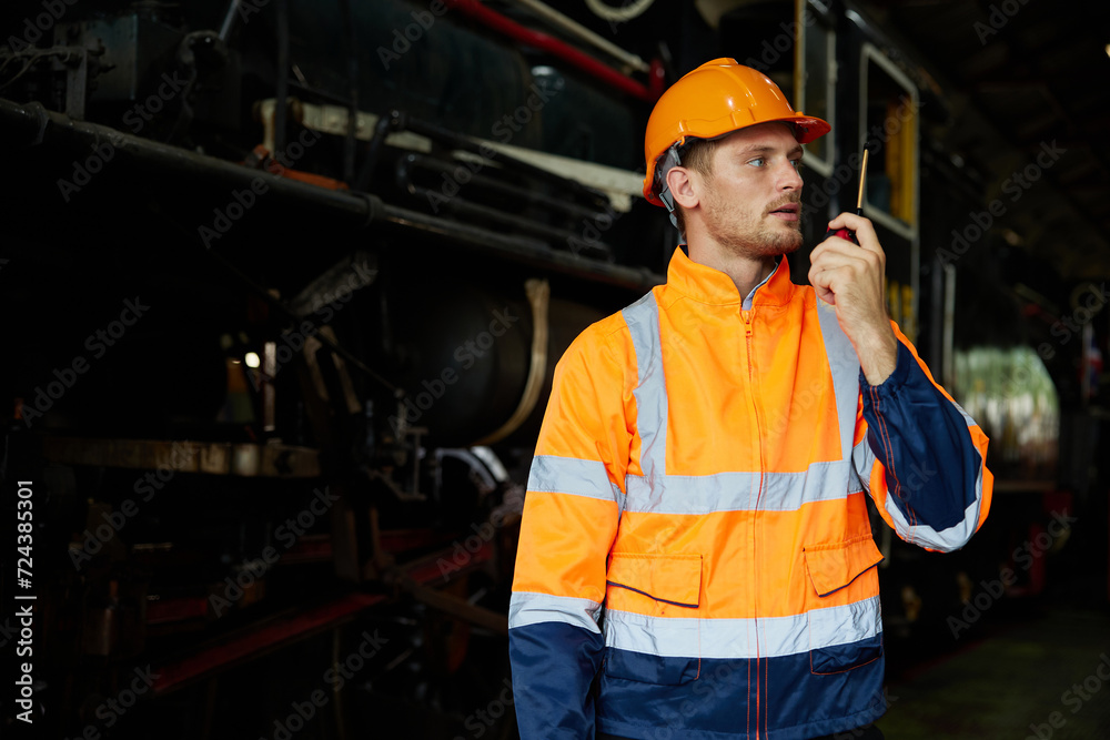 worker using walkie talkie and talking about work at construction train station worker using walkie talkie and talking about work at construction train station