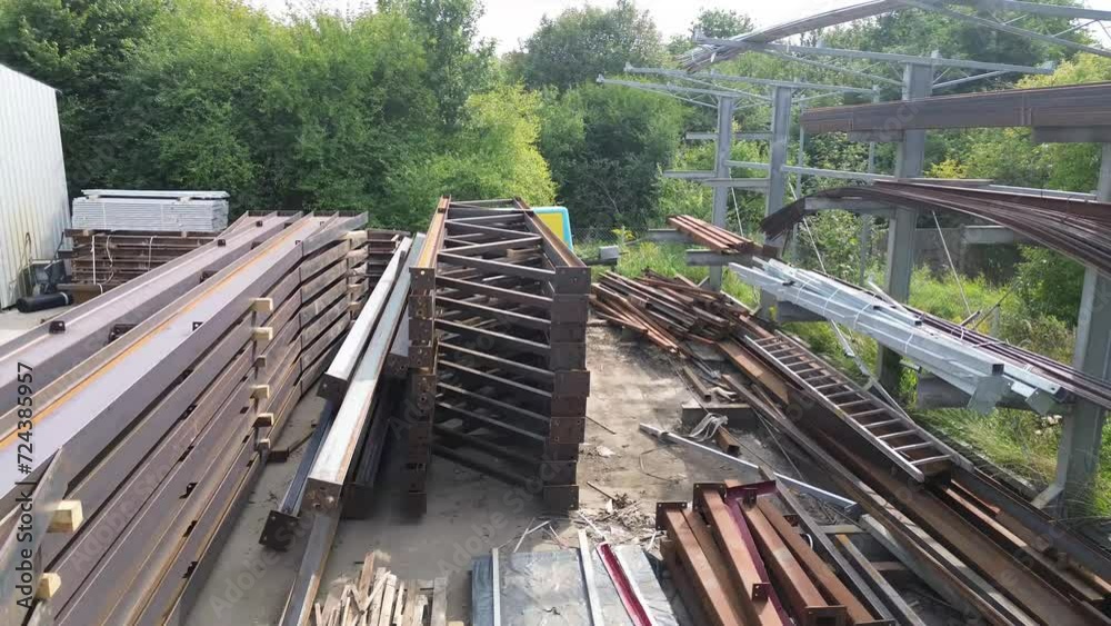 Drone soars over metal groundwork—a captivating aerial view of construction elements at rest in this dynamic stock footage. Drone soars over metal groundwork—a captivating aerial view of construction elements at rest in this dynamic stock footage.