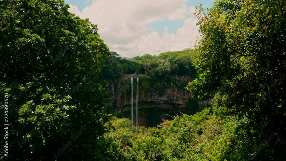 Chamarel waterfall in the Mauritius island from high view point. Tropical waterfall surrounded by green lush vegetation. Touristic attraction. Tropical oasis, nature reserve. Rainforest beauty. Chamarel waterfall in the Mauritius island from high view point. Tropical waterfall surrounded by green lush vegetation. Touristic attraction. Tropical oasis, nature reserve. Rainforest beauty.