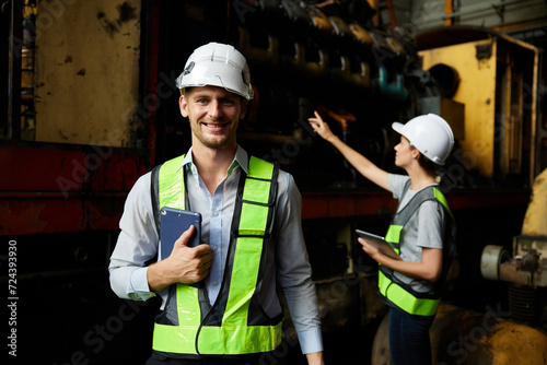 portrait engineer or worker smiling and checking construction train at station