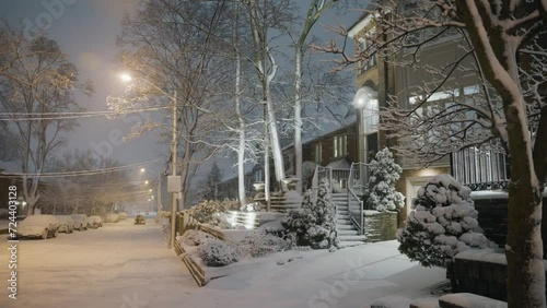 A beautiful house, garden and street covered with snow after a winter storm blew threw the city and covered everything. photo