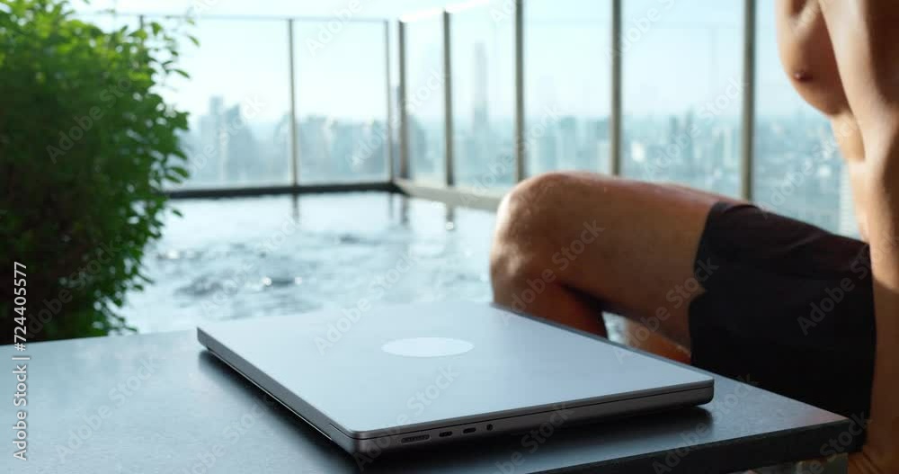 Man closes laptop heads pool against cityscape. Technology, symbolizing work-life balance, highlights integration technology modern life. scene captures seamless blend technology leisure.