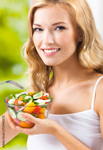 Portrait image - happy smiling young woman with vegetable salad at home house, indoors. Healthy eating, vegetarian, keto ketogenic diet concept.