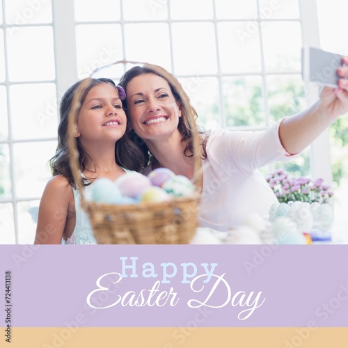 Composition of happy easter day text over caucasian mother and daughter taking selfie