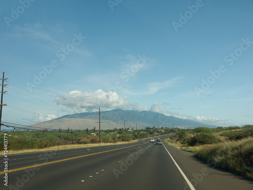 Driving by Hawaiian road to West Maui on sunny day