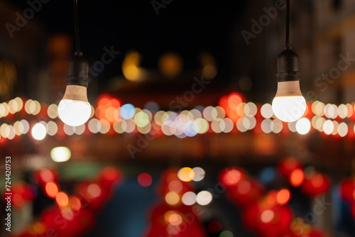 Warm light bulbs line the walkway with bokeh in the background. During the Chinese New Year festival in Chinatown, the culture of people in Asia Looks beautiful and outstanding. © Nutchapong Wuttisak