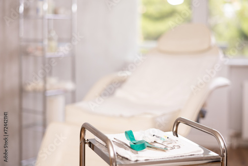 Interior of modern aesthetic cosmetolody clinic with chair for patient and equipment for cosmetic procedures photo