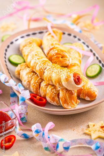Pig in blanket, long sausages wrapped in yeast dough - traditional carnival, Fasching and party food