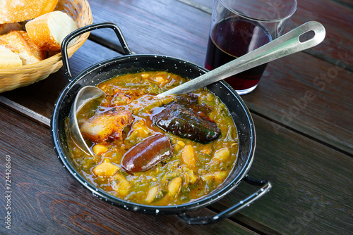 Traditional Asturian rich stew with cabbage, potatoes, beans and compango (Pote asturiano) photo