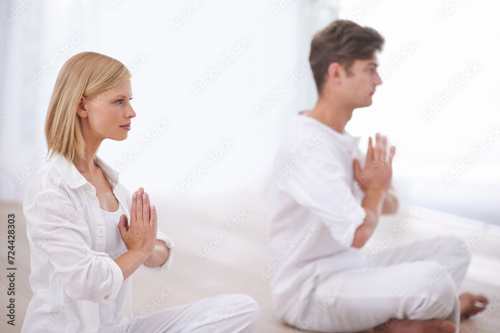 Praying hands, meditation and couple on a floor for peace, balance and spirituality in their home together. Balance, profile and people in a living room for zen, stress relief or holistic self care Praying hands, meditation and couple on a floor for peace, balance and spirituality in their home together. Balance, profile and people in a living room for zen, stress relief or holistic self care
