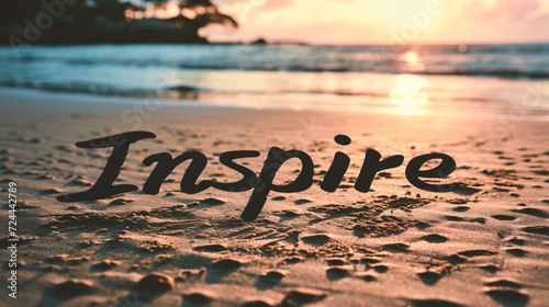 Inscription Inspire on the sand of a tropical beach at sunset