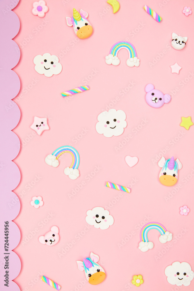 Trendy pastel pink kawaii background with cute air plasticine handmade cartoon animals, unicorns, stars, sweet marshmallows, rainbows pattern. Top view, flat lay. Candycore, fairycore.
