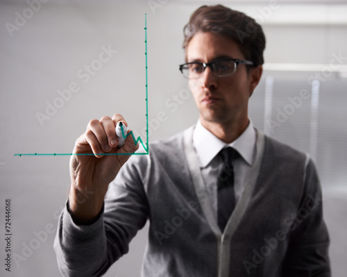 Businessman  writing and glass with graph in office  brainstorming and planning with idea in workplace. Finance professional  thinking or pen in problem solving  chart or solution in corporate career
