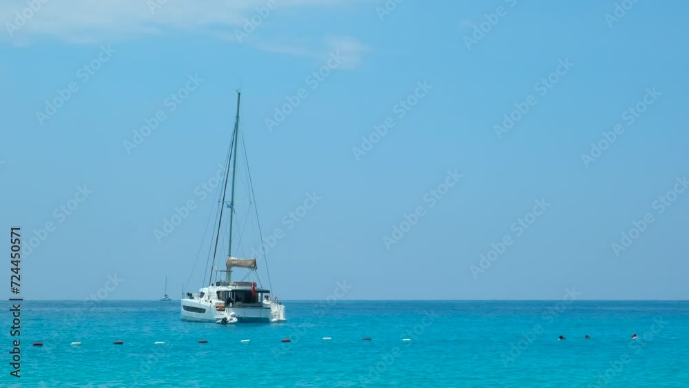 Sailing dinghie in the turquoise sea. A view of touristic motor yacht sailings in the turquoise sea waves in summer. Sailing dinghie in the turquoise sea. A view of touristic motor yacht sailings in the turquoise sea waves in summer.