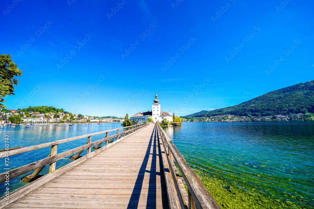 View of Ort Castle, Lake Traunsee and the surrounding landscape. Idyllic nature by the lake in Styria in Austria. Bergsee am Totes Gebirge in the Salzkammergut.
