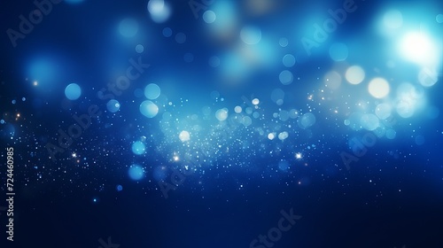 Blue glowing particles on dark background with bokeh effect © Ameer