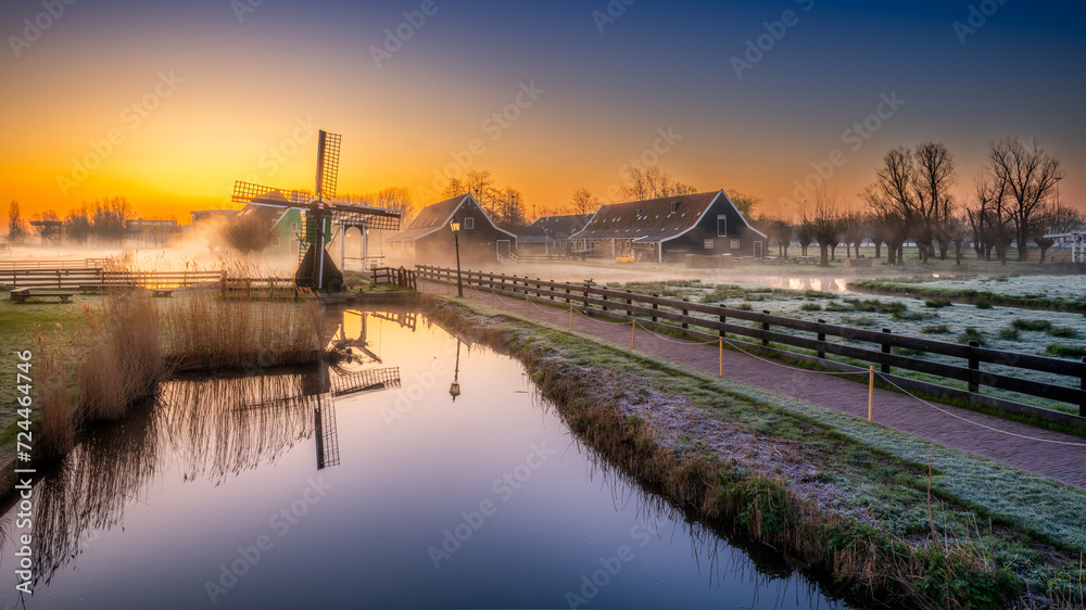View of the windmills of Zaanse Schans shrouded in fog at dawn. Holland, Netherlands View of the windmills of Zaanse Schans shrouded in fog at dawn. Holland, Netherlands