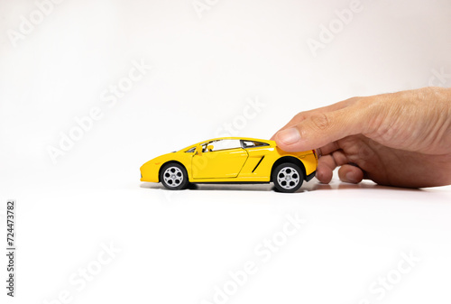 Hand holding a toy car isolated on white background. After some edits.