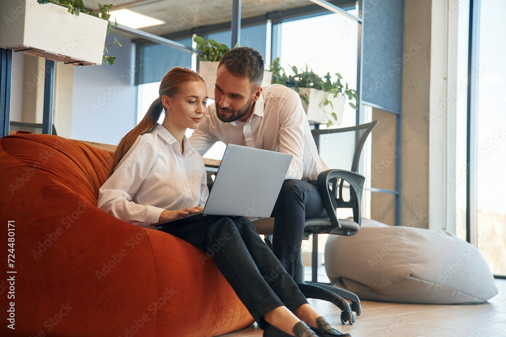 Affectionate lovely look. Man and woman employees are working in the office Affectionate lovely look. Man and woman employees are working in the office
