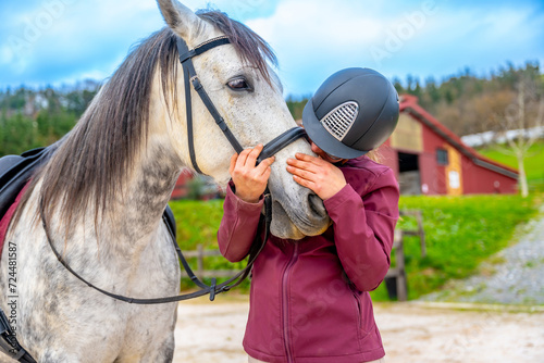Woman kissing a horse in the noise