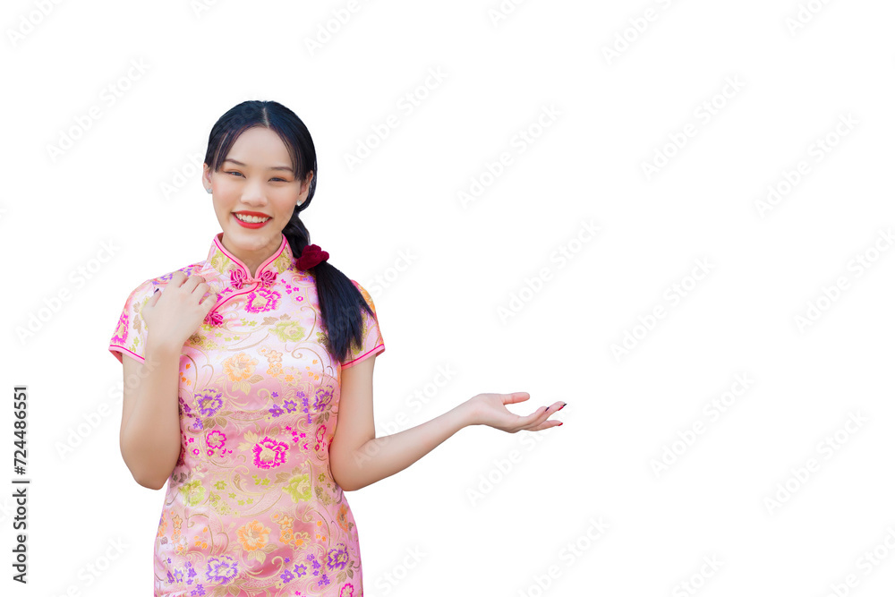 Asian woman with long hair who wears pink Cheongsam dress in Chinese new year theme while her hand shows to present something and looks at camera smiling happily while isolated white background. Asian woman with long hair who wears pink Cheongsam dress in Chinese new year theme while her hand shows to present something and looks at camera smiling happily while isolated white background.