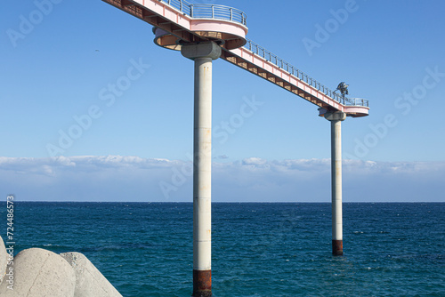 There is a skywalk bridge over the sea