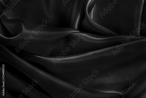 Black fabric cloth texture for background and design art work, beautiful crumpled pattern of silk or linen.